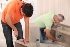 Father and son assembling furniture